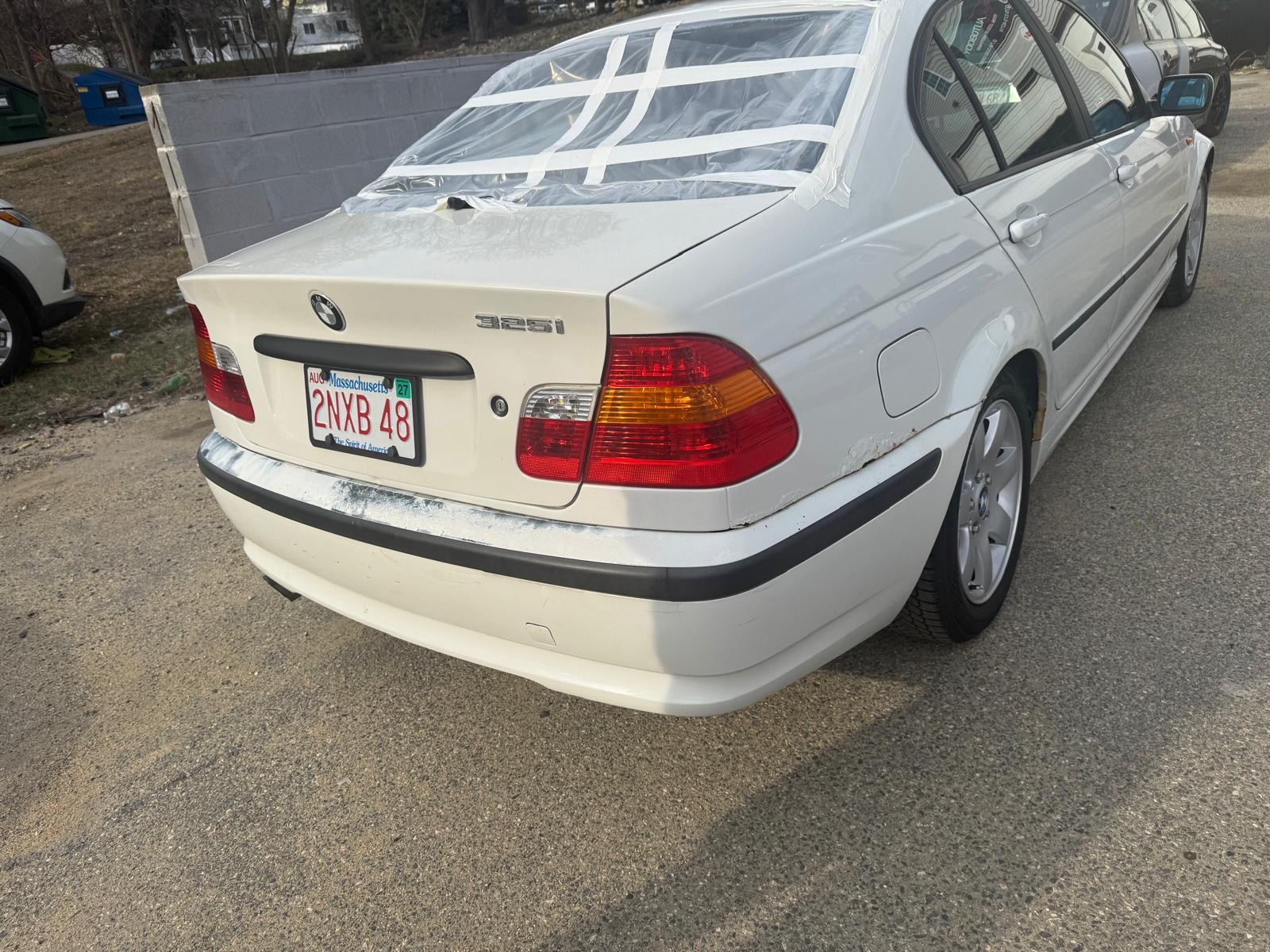 Before photo of BMW 325i rear bumper damage with masked rear window at R&K Auto Body in Haverhill MA